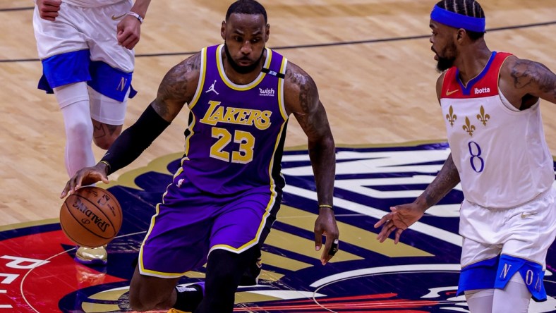 May 16, 2021; New Orleans, Louisiana, USA; Los Angeles Lakers forward LeBron James (23) dribbles against New Orleans Pelicans forward Naji Marshall (8) during the first half at the Smoothie King Center. Mandatory Credit: Stephen Lew-USA TODAY Sports