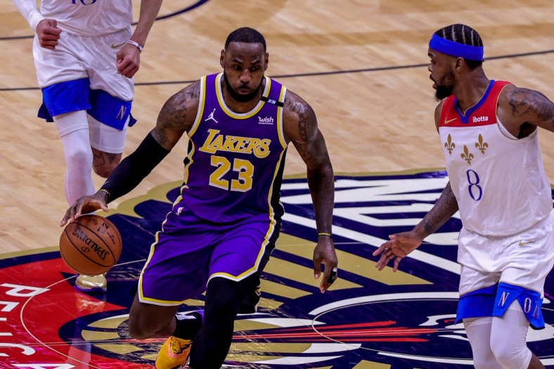 May 16, 2021; New Orleans, Louisiana, USA; Los Angeles Lakers forward LeBron James (23) dribbles against New Orleans Pelicans forward Naji Marshall (8) during the first half at the Smoothie King Center. Mandatory Credit: Stephen Lew-USA TODAY Sports