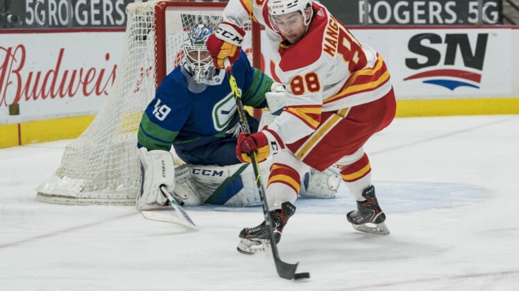 May 16, 2021; Vancouver, British Columbia, CAN; Vancouver Canucks goalie Braden Holtby (49) watches Calgary Flames forward Andrew Mangiapane (88) control he puck in the second period at Rogers Arena. Mandatory Credit: Bob Frid-USA TODAY Sports