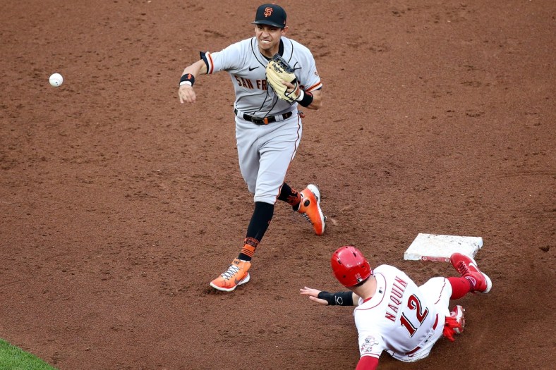 San Francisco Giants third baseman Wilmer Flores (41) turns a double play ball off the bat of Cincinnati Reds shortstop Eugenio Suarez (7) (not pictured) as Cincinnati Reds center fielder Tyler Naquin (12) slides into second base in the third inning during a baseball game, Monday, May 17, 2021, at Great American Ball Park in Cincinnati.

San Francisco Giants At Cincinnati Reds May 17