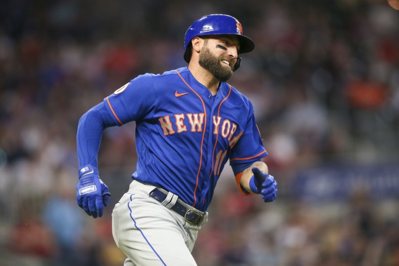 May 17, 2021; Atlanta, Georgia, USA; New York Mets center fielder Kevin Pillar (11) runs to first after hitting a double against the Atlanta Braves in the sixth inning at Truist Park. Mandatory Credit: Brett Davis-USA TODAY Sports