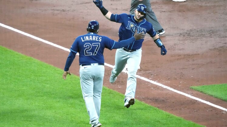 May 18, 2021; Baltimore, Maryland, USA; Tampa Bay Rays catcher Mike Zunino (10) is greeted by third base coach Rodney Linares (27) following his two run home run in the third inning against the Baltimore Orioles at Oriole Park at Camden Yards. Mandatory Credit: Mitch Stringer-USA TODAY Sports