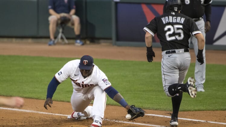 May 18, 2021; Minneapolis, Minnesota, USA; Chicago White Sox first baseman Andrew Vaughn (25) reaches first base before Minnesota Twins first baseman Miguel Sano (22) can catch the ball in the second inning at Target Field. Mandatory Credit: Jesse Johnson-USA TODAY Sports