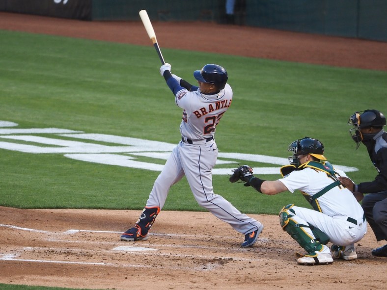 May 18, 2021; Oakland, California, USA; Houston Astros left fielder Michael Brantley (23) hits a single against the Oakland Athletics during the third inning at RingCentral Coliseum. Mandatory Credit: Kelley L Cox-USA TODAY Sports