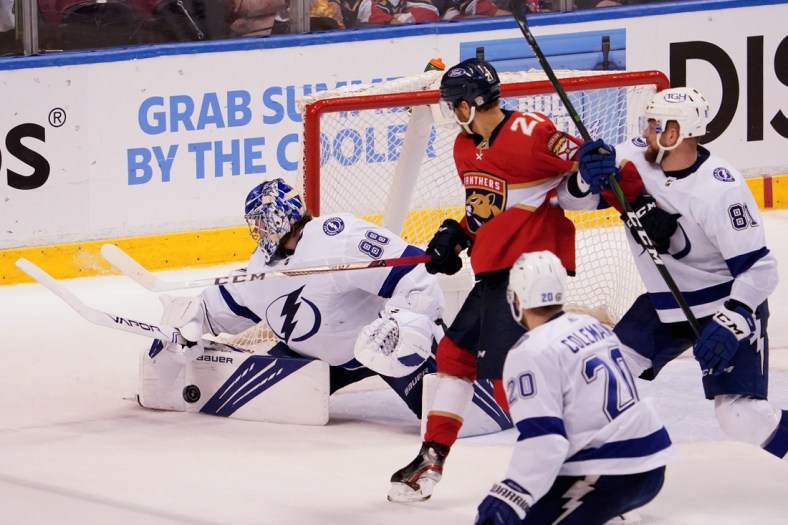 May 18, 2021; Sunrise, Florida, USA; Tampa Bay Lightning goaltender Andrei Vasilevskiy (88) blocks a shot behind Florida Panthers center Alex Wennberg (21) during the third period in game two of the first round of the 2021 Stanley Cup Playoffs at BB&T Center. Mandatory Credit: Jasen Vinlove-USA TODAY Sports