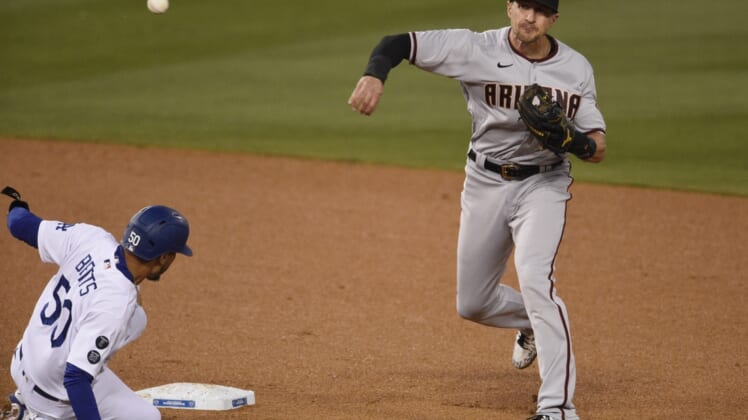 May 18, 2021; Los Angeles, California, USA; Arizona Diamondbacks shortstop Nick Ahmed (13) throws to first after forcing out Los Angeles Dodgers center fielder Mookie Betts (50) at second base during the third inning at Dodger Stadium. Mandatory Credit: Kelvin Kuo-USA TODAY Sports
