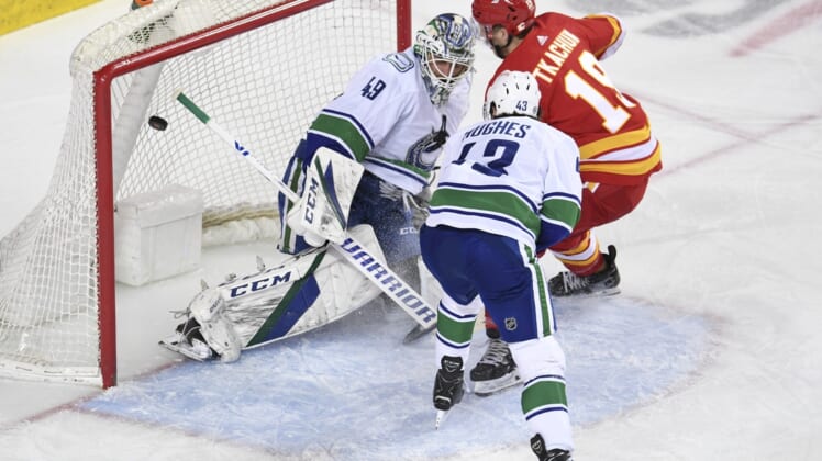 May 19, 2021; Calgary, Alberta, CAN; Calgary Flames forward Matthew Tkachuk (19) scores on Vancouver Canucks goalie Braden Holtby (49) during the first period at Scotiabank Saddledome. Mandatory Credit: Candice Ward-USA TODAY Sports