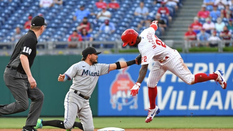 May 19, 2021; Philadelphia, Pennsylvania, USA;  Miami Marlins shortstop Miguel Rojas (19) tags out Philadelphia Phillies center fielder Andrew McCutchen (22) during the first inning at Citizens Bank Park. Mandatory Credit: Eric Hartline-USA TODAY Sports
