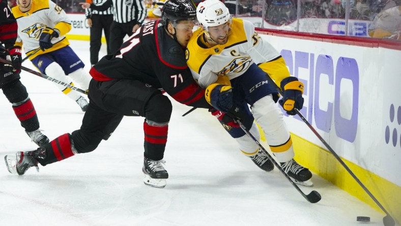 May 19, 2021; Raleigh, North Carolina, USA; Nashville Predators defenseman Roman Josi (59) skates with the puck against Carolina Hurricanes right wing Jesper Fast (71) during the first period in game two of the first round of the 2021 Stanley Cup Playoffs at PNC Arena. Mandatory Credit: James Guillory-USA TODAY Sports