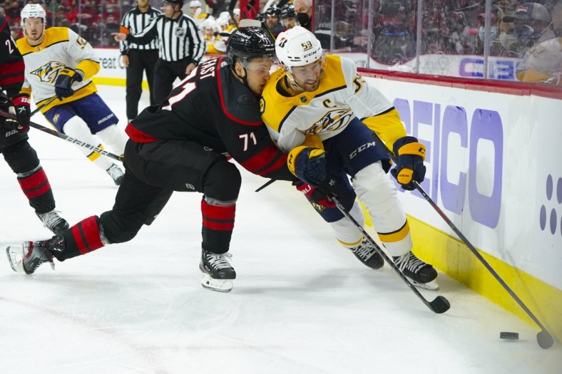 May 19, 2021; Raleigh, North Carolina, USA; Nashville Predators defenseman Roman Josi (59) skates with the puck against Carolina Hurricanes right wing Jesper Fast (71) during the first period in game two of the first round of the 2021 Stanley Cup Playoffs at PNC Arena. Mandatory Credit: James Guillory-USA TODAY Sports