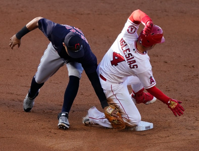 May 19, 2021; Anaheim, California, USA; Los Angeles Angels shortstop Jose Iglesias (4) slides into second base with a double as Cleveland Indians second baseman Cesar Hernandez (7) is late with the tag during the third inning at Angel Stadium. Mandatory Credit: Robert Hanashiro-USA TODAY Sports