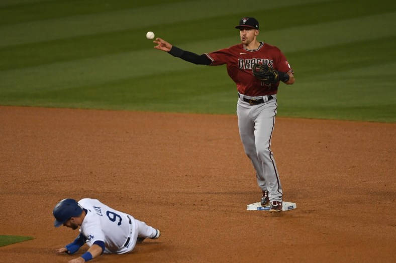 May 19, 2021; Los Angeles, California, USA; Los Angeles Dodgers second baseman Gavin Lux (9) is out against Arizona Diamondbacks shortstop Nick Ahmed (13) in a double play in the fifth inning at Dodger Stadium. Mandatory Credit: Richard Mackson-USA TODAY Sports