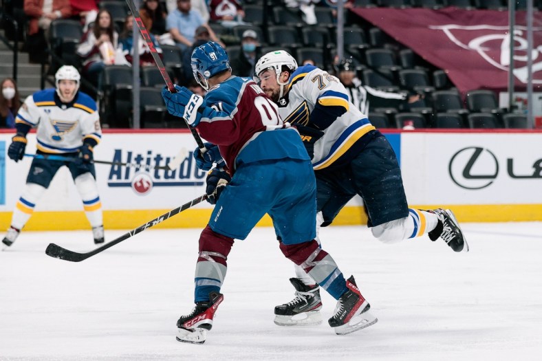 May 19, 2021; Denver, Colorado, USA; Colorado Avalanche center Nazem Kadri (91) checks St. Louis Blues defenseman Justin Faulk (72) in the third period in game two of the first round of the 2021 Stanley Cup Playoffs at Ball Arena. Kadri would be ejected from the game for an illegal hit to the head. Mandatory Credit: Isaiah J. Downing-USA TODAY Sports