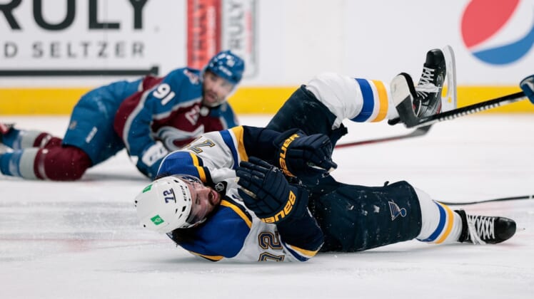 May 19, 2021; Denver, Colorado, USA; St. Louis Blues defenseman Justin Faulk (72) falls to the ice after being hit in the third period by Colorado Avalanche center Nazem Kadri (91) in game two of the first round of the 2021 Stanley Cup Playoffs at Ball Arena. Kadri would be ejected from the game for an illegal hit to the head. Mandatory Credit: Isaiah J. Downing-USA TODAY Sports