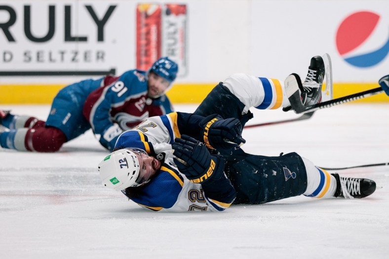 May 19, 2021; Denver, Colorado, USA; St. Louis Blues defenseman Justin Faulk (72) falls to the ice after being hit in the third period by Colorado Avalanche center Nazem Kadri (91) in game two of the first round of the 2021 Stanley Cup Playoffs at Ball Arena. Kadri would be ejected from the game for an illegal hit to the head. Mandatory Credit: Isaiah J. Downing-USA TODAY Sports