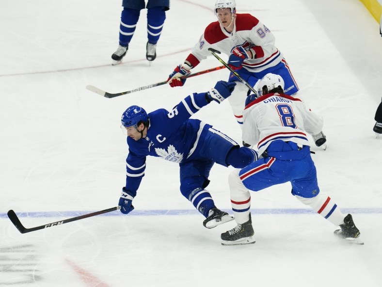 May 20, 2021; Toronto, Ontario, CAN; Toronto Maple Leafs forward John Tavares (91) is hit by Montreal Canadiens defenseman Ben Chiarot (8) during the first period of game one of the first round of the 2021 Stanley Cup Playoffs at Scotiabank Arena. Mandatory Credit: John E. Sokolowski-USA TODAY Sports