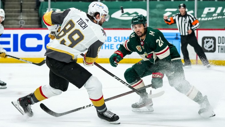 May 20, 2021; Saint Paul, Minnesota, USA; Minnesota Wild defenseman Matt Dumba (24) blocks a shot from Vegas Golden Knights forward Alex Tuch (89) during the first period in game three of the first round of the 2021 Stanley Cup Playoffs at Xcel Energy Center. Mandatory Credit: Brace Hemmelgarn-USA TODAY Sports