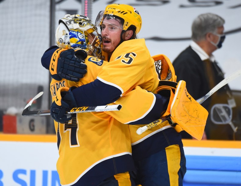 May 21, 2021; Nashville, Tennessee, USA; Nashville Predators center Matt Duchene (95) celebrates with goaltender Juuse Saros (74) after scoring the game-winning goal in the second overtime against the Carolina Hurricanes in game three of the first round of the 2021 Stanley Cup Playoffs at Bridgestone Arena. Mandatory Credit: Christopher Hanewinckel-USA TODAY Sports