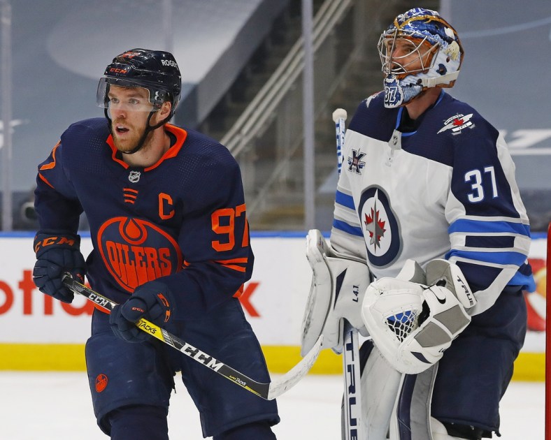 May 21, 2021; Edmonton, Alberta, CAN; Edmonton Oilers forward Connor McDavid (97) tries to screen Winnipeg Jets goaltender Connor Hellebuyck (37) during the third period in game two of the first round of the 2021 Stanley Cup Playoffs at Rogers Place. Mandatory Credit: Perry Nelson-USA TODAY Sports