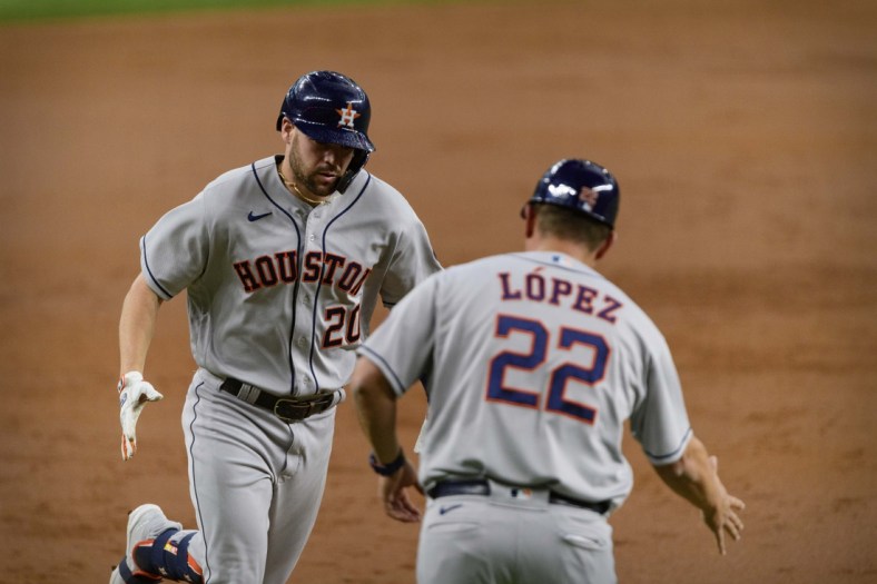May 22, 2021; Arlington, Texas, USA; Houston Astros center fielder Chas McCormick (20) and first base coach Omar Lopez (22) celebrate McCormick hitting a home run against the Texas Rangers during the second inning at Globe Life Field. Mandatory Credit: Jerome Miron-USA TODAY Sports