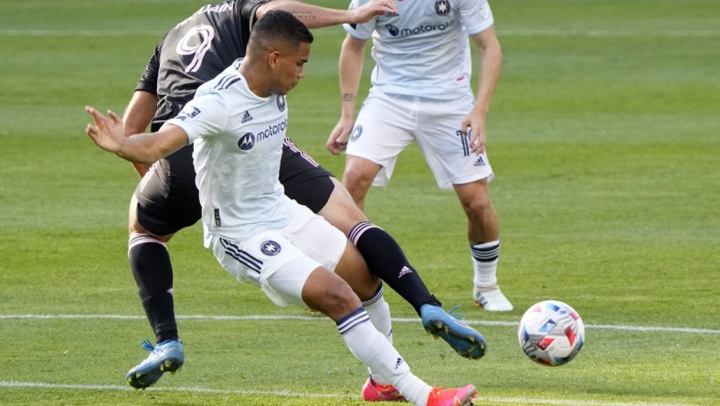 May 22, 2021; Chicago, Illinois, USA; Chicago Fire defender Miguel Angel Navarro (6) steals the ball from Inter Miami forward Gonzalo Higuain (9) during the first half at Soldier Field. Mandatory Credit: Mike Dinovo-USA TODAY Sports