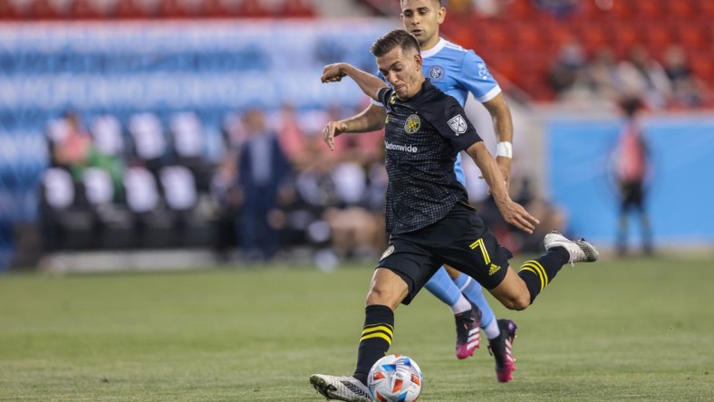 May 22, 2021; Harrison, New Jersey, USA; Columbus Crew forward Pedro Santos (7) kicks the ball against New York City FC during the first half at Red Bull Arena. Mandatory Credit: Vincent Carchietta-USA TODAY Sports