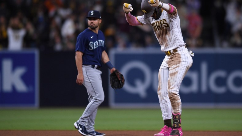 May 22, 2021; San Diego, California, USA; San Diego Padres shortstop Fernando Tatis Jr. (right) reacts on second base after hitting a double during the seventh inning as Seattle Mariners second baseman Jack Mayfield (left) looks on at Petco Park. Mandatory Credit: Orlando Ramirez-USA TODAY Sports