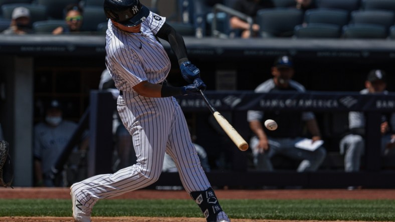 May 23, 2021; Bronx, New York, USA; New York Yankees third baseman Gio Urshela (29) hits a single during the third inning against the Chicago White Sox at Yankee Stadium. Mandatory Credit: Vincent Carchietta-USA TODAY Sports