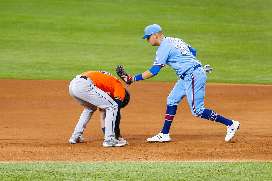 May 23, 2021; Arlington, Texas, USA; Texas Rangers first baseman Nate Lowe (30) tags out Houston Astros left fielder Kyle Tucker (30) during a pick off throw in the second inning at Globe Life Field. Mandatory Credit: Andrew Dieb-USA TODAY Sports