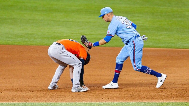 May 23, 2021; Arlington, Texas, USA; Texas Rangers first baseman Nate Lowe (30) tags out Houston Astros left fielder Kyle Tucker (30) during a pick off throw in the second inning at Globe Life Field. Mandatory Credit: Andrew Dieb-USA TODAY Sports