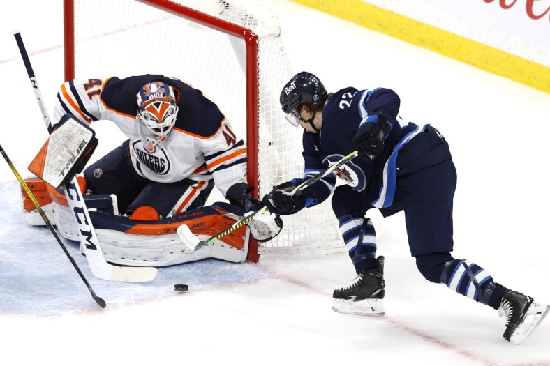 May 23, 2021; Winnipeg, Manitoba, CAN; Winnipeg Jets center Mason Appleton (22) shoots on Edmonton Oilers goaltender Mike Smith (41) int the second period in game three of the first round of the 2021 Stanley Cup Playoffs at Bell MTS Place. Mandatory Credit: James Carey Lauder-USA TODAY Sports