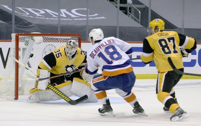 May 24, 2021; Pittsburgh, Pennsylvania, USA; New York Islanders left wing Anthony Beauvillier (18) scores a goal against Pittsburgh Penguins goaltender Tristan Jarry (35) as center Sidney Crosby (87) defends during the first period in game five of the first round of the 2021 Stanley Cup Playoffs at PPG Paints Arena. Mandatory Credit: Charles LeClaire-USA TODAY Sports