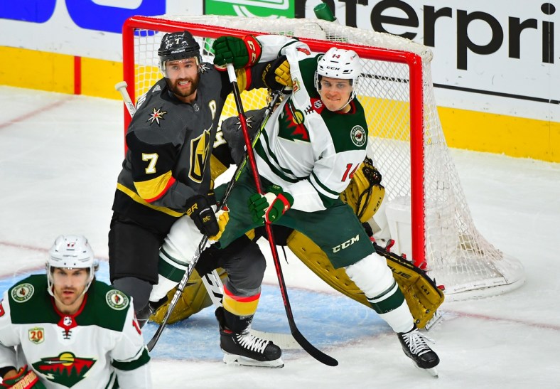 May 24, 2021; Las Vegas, Nevada, USA; Vegas Golden Knights defenseman Alex Pietrangelo (7) battles for position against Minnesota Wild center Joel Eriksson Ek (14) in front of Vegas Golden Knights goaltender Marc-Andre Fleury (29) during the first period of game five of the first round of the 2021 Stanley Cup Playoffs at T-Mobile Arena. Mandatory Credit: Stephen R. Sylvanie-USA TODAY Sports