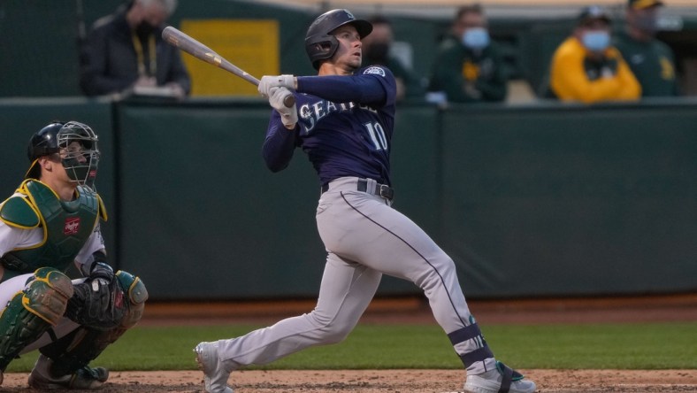 May 24, 2021; Oakland, California, USA;  Seattle Mariners center fielder Jarred Kelenic (10) hits a solo home run against the Oakland Athletics during the fifth inning at RingCentral Coliseum. Mandatory Credit: Stan Szeto-USA TODAY Sports