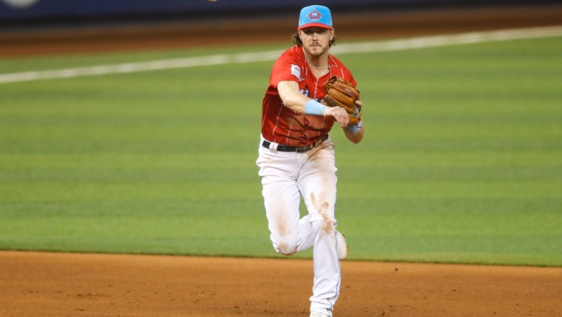 May 21, 2021; Miami, Florida, USA; Miami Marlins third baseman Brian Anderson (15) throws to first base and takes out New York Mets left fielder Cameron Maybin (not pictured) in the ninth inning at loanDepot Park. Mandatory Credit: Sam Navarro-USA TODAY Sports