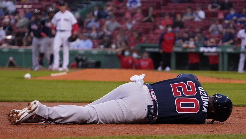 May 25, 2021; Boston, Massachusetts, USA; Atlanta Braves left fielder Marcell Ozuna (20) lays on the field with an injury after being tagged out at third during the third inning against the Boston Red Sox at Fenway Park. Mandatory Credit: David Butler II-USA TODAY Sports