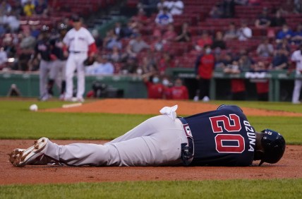 May 25, 2021; Boston, Massachusetts, USA; Atlanta Braves left fielder Marcell Ozuna (20) lays on the field with an injury after being tagged out at third during the third inning against the Boston Red Sox at Fenway Park. Mandatory Credit: David Butler II-USA TODAY Sports