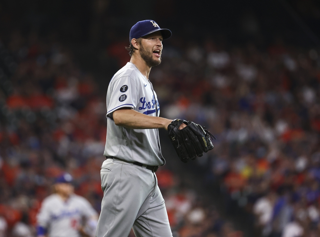 May 25, 2021; Houston, Texas, USA; Los Angeles Dodgers starting pitcher Clayton Kershaw (22) reacts after a play during the second inning against the Houston Astros at Minute Maid Park. Mandatory Credit: Troy Taormina-USA TODAY Sports