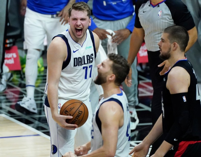 May 25, 2021; Los Angeles, California, USA; Dallas Mavericks guard Luka Doncic (77) and forward Maxi Kleber (foreground) react after defeating the LA Clippers in game two of the first round of the 2021 NBA Playoffs at Staples Center. Mandatory Credit: Robert Hanashiro-USA TODAY Sports