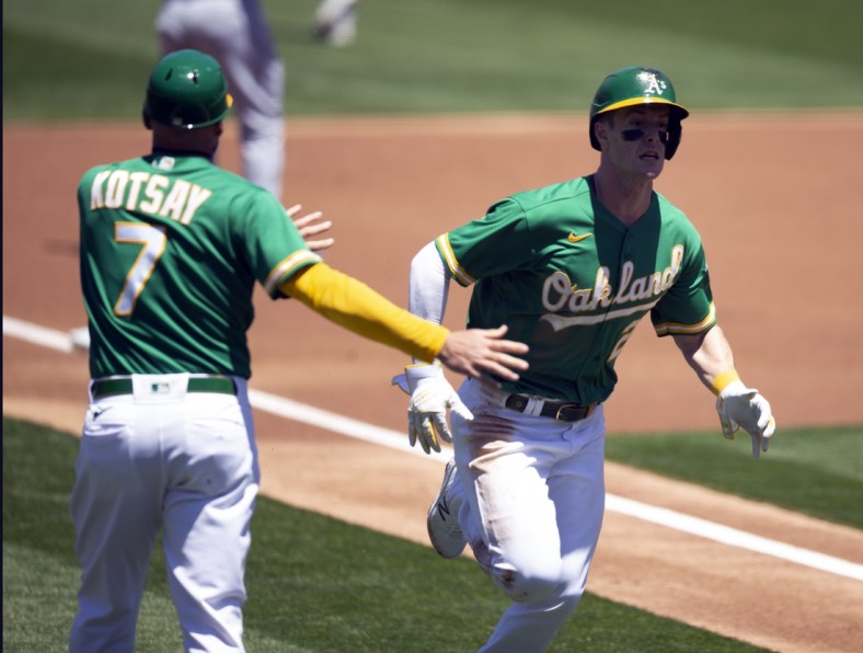 May 26, 2021; Oakland, California, USA; Oakland Athletics designated hitter Mark Canha (20) scores on a ground rule double by left fielder Seth Brown during the first inning against the Seattle Mariners at RingCentral Coliseum. Mandatory Credit: D. Ross Cameron-USA TODAY Sports