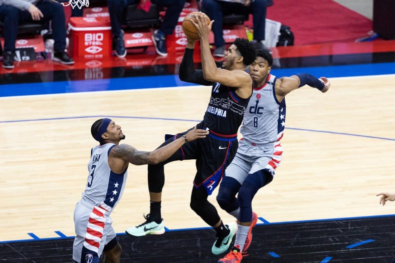 May 26, 2021; Philadelphia, Pennsylvania, USA; Philadelphia 76ers forward Tobias Harris (12) moves to the basket against Washington Wizards guard Bradley Beal (3) and forward Rui Hachimura (8) during the first quarter of game two in the first round of the 2021 NBA Playoffs at Wells Fargo Center. Mandatory Credit: Bill Streicher-USA TODAY Sports