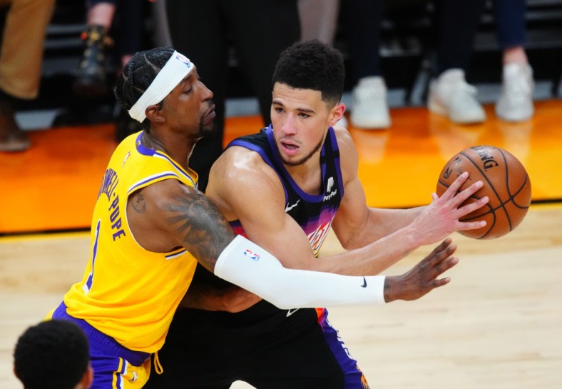 May 25, 2021; Phoenix, Arizona, USA; Phoenix Suns guard Devin Booker (right) against Los Angeles Lakers guard Kentavious Caldwell-Pope during game two in the first round of the 2021 NBA Playoffs at Phoenix Suns Arena. Mandatory Credit: Mark J. Rebilas-USA TODAY Sports