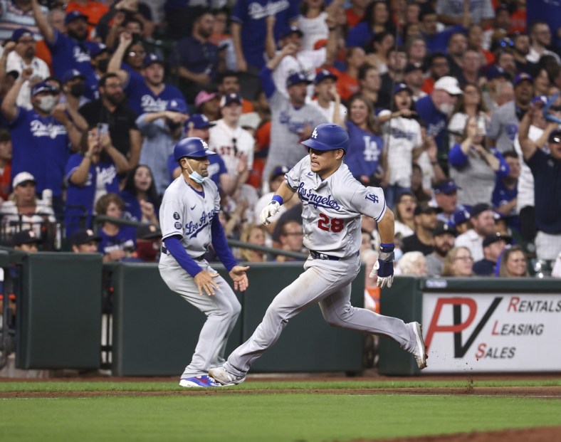 May 26, 2021; Houston, Texas, USA; Los Angeles Dodgers left fielder Yoshi Tsutsugo (28) rounds third base and scores a run during the third inning against the Houston Astros at Minute Maid Park. Mandatory Credit: Troy Taormina-USA TODAY Sports