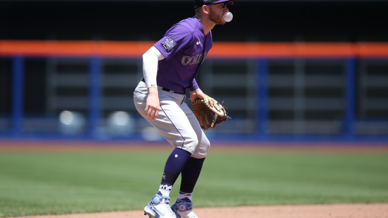 May 27, 2021; New York City, New York, USA; Colorado Rockies shortstop Trevor Story (27)  blows a bubblegum bubble while fielding his position during the fifth inning against the New York Mets at Citi Field. Mandatory Credit: Brad Penner-USA TODAY Sports