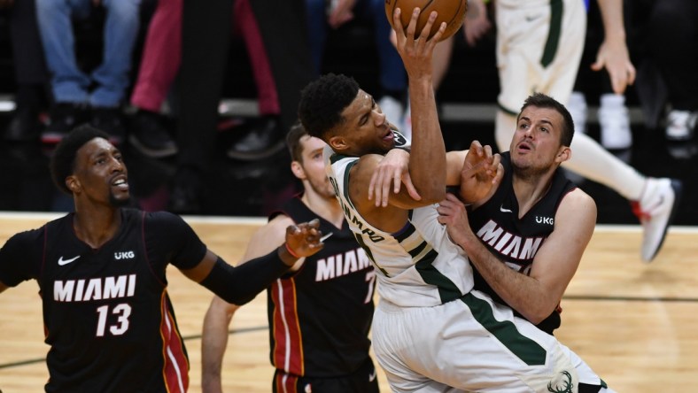 May 27, 2021; Miami, Florida, USA; Miami Heat forward Nemanja Bjelica (70) fouls Milwaukee Bucks forward Giannis Antetokounmpo (34) in the second half during game three in the first round of the 2021 NBA Playoffs at American Airlines Arena. Mandatory Credit: Jim Rassol-USA TODAY Sports