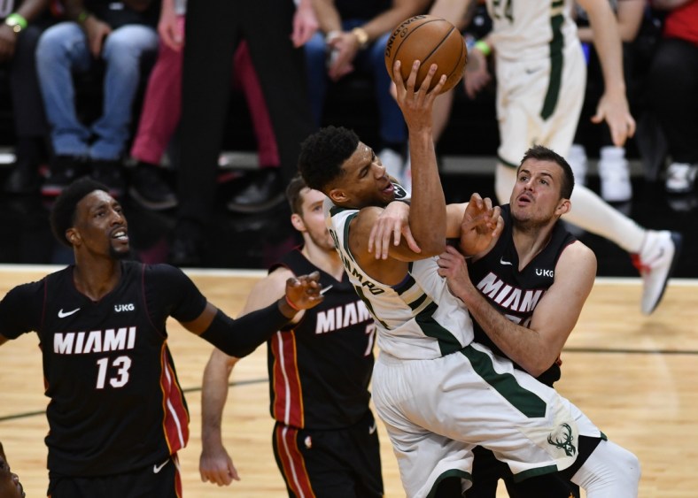 May 27, 2021; Miami, Florida, USA; Miami Heat forward Nemanja Bjelica (70) fouls Milwaukee Bucks forward Giannis Antetokounmpo (34) in the second half during game three in the first round of the 2021 NBA Playoffs at American Airlines Arena. Mandatory Credit: Jim Rassol-USA TODAY Sports