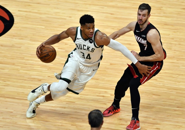 May 27, 2021; Miami, Florida, USA; Milwaukee Bucks forward Giannis Antetokounmpo (34) drives past Miami Heat guard Goran Dragic (7) in the second half during game three in the first round of the 2021 NBA Playoffs at American Airlines Arena. Mandatory Credit: Jim Rassol-USA TODAY Sports
