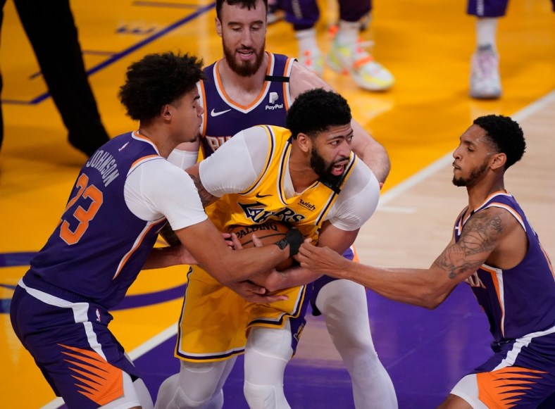 May 27, 2021; Los Angeles, California, USA; Los Angeles Lakers forward Anthony Davis (3) is surrounded by Phoenix Suns forward Cameron Johnson (23), forward Frank Kaminsky (8) and guard Cameron Payne (15) during the fourth quarter of game three in the first round of the 2021 NBA Playoffs at Staples Center. Mandatory Credit: Robert Hanashiro-USA TODAY Sports