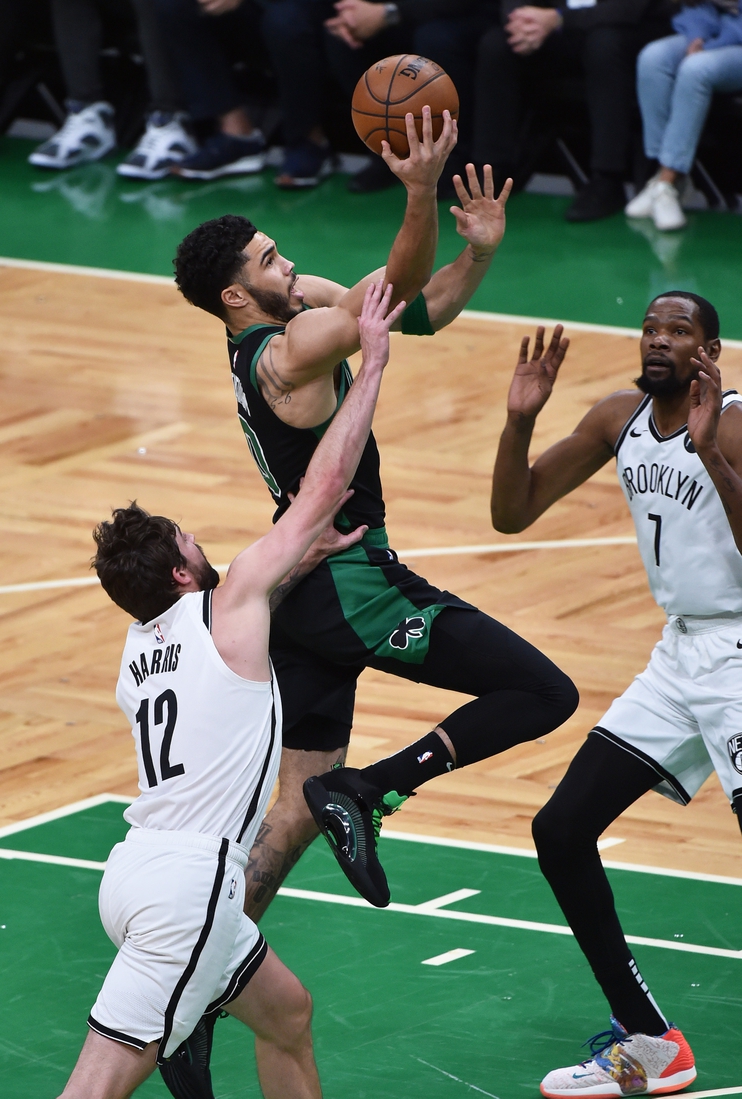 May 28, 2021; Boston, Massachusetts, USA; Boston Celtics forward Jayson Tatum (0) drives to the basket between Brooklyn Nets forward Joe Harris (12) and forward Kevin Durant (7) during the first half during game three in the first round of the 2021 NBA Playoffs at TD Garden. Mandatory Credit: Bob DeChiara-USA TODAY Sports