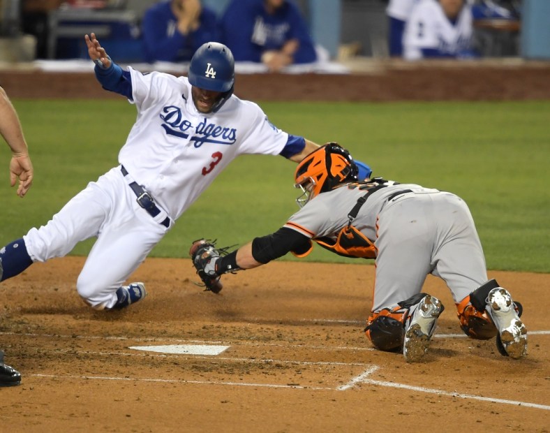 May 28, 2021; Los Angeles, California, USA; Los Angeles Dodgers left fielder Chris Taylor (3) is tagged out at the plate by San Francisco Giants catcher Buster Posey (28) during the fourth inning at Dodger Stadium. Mandatory Credit: Jayne Kamin-Oncea-USA TODAY Sports